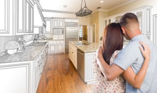 Young Military Couple Looking Inside Custom Kitchen and Design Drawing Combination. Young Military Couple Looking Inside Custom Kitchen and Design Drawing Combination.